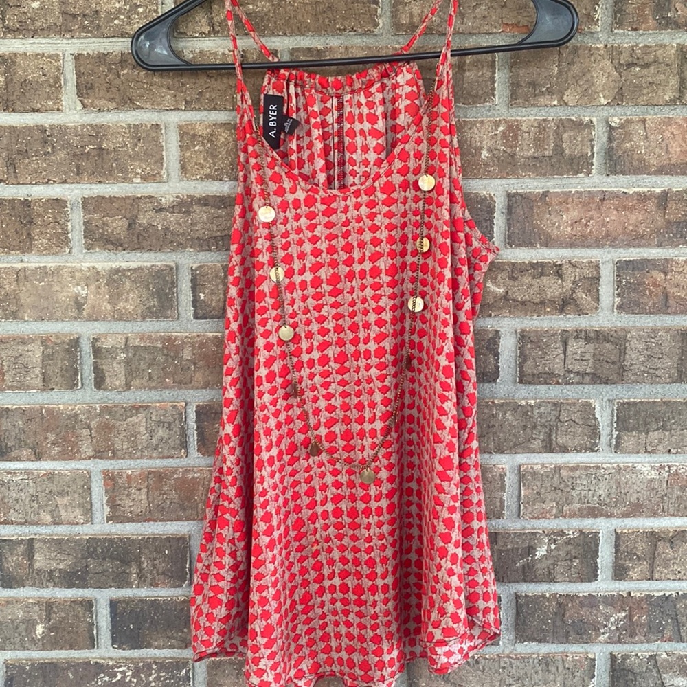 Sleeveless tank by a buyer has attached gold brushed necklace